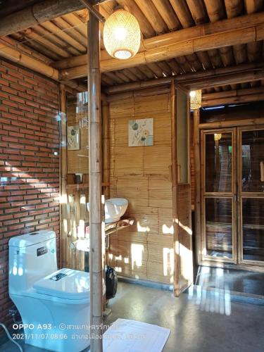 a bathroom with a sink and a toilet at สวนเกษตรรักษ์ไผ่ Bamboo Conservation Farm in Surin
