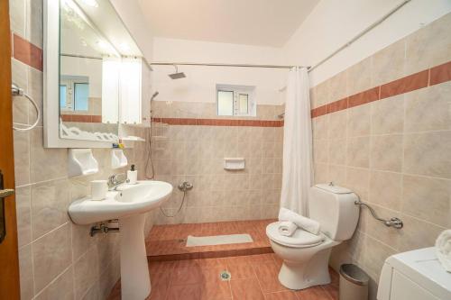 a bathroom with a toilet and a sink at Afroditi Holiday Home - Blue Apartment in Svoronata