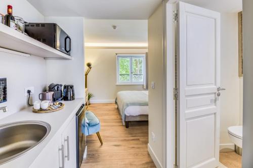 a bathroom with a sink and a bed in a room at Domaine de Boulouch in Lectoure