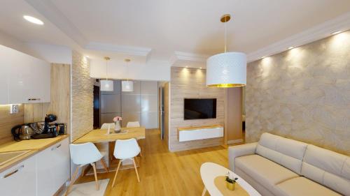 eine Küche und ein Wohnzimmer mit einer Couch und einem Tisch in der Unterkunft Zagreb4you Apartments in Zagreb