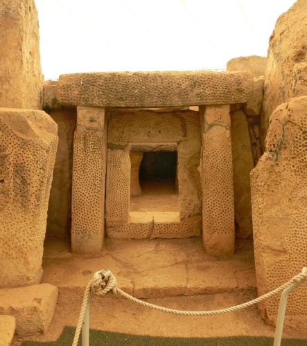a stone building with a rope in front of it at Dar il-Hena in Żurrieq