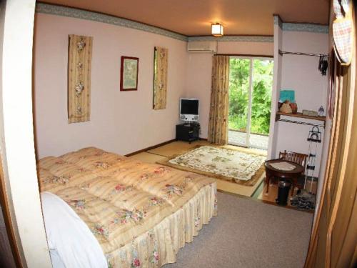 um quarto com uma cama grande e uma janela em Gasthof yell / Vacation STAY 79366 em Kuroiso