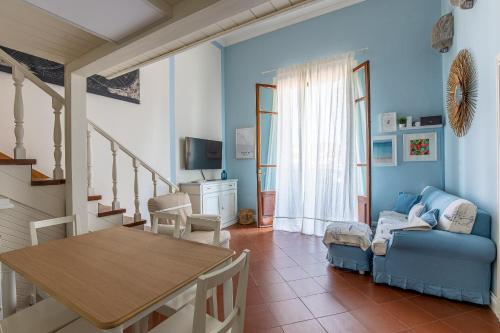 a living room with a table and a couch at Suite Carducci Viareggio in Viareggio