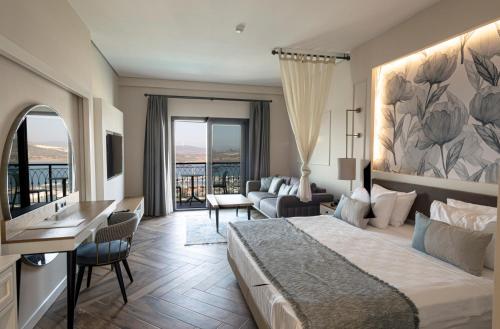 a hotel room with a bed and a living room at Soliport Hotel & SPA in Alaçatı