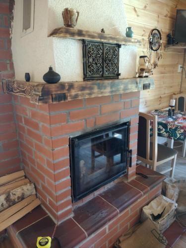 a brick fireplace in a living room at Gabel&Jurgen in Mirsk