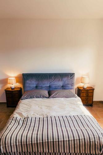a large bed in a room with two night stands at Bed and Breakfast Villa Romano in Anzio
