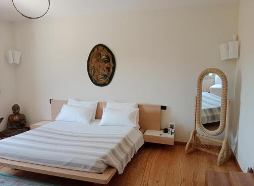 a bedroom with a large bed and a mirror at Villa luce e relax in Saturnia