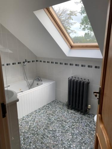 a bathroom with a bath tub and a window at Captivating 4-Bed House in west Wales in Pencader