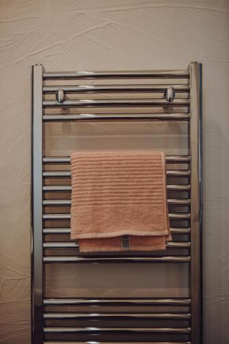 a towel hanging on a towel rack in a bathroom at Lizzie's Cottage in Drumaroad
