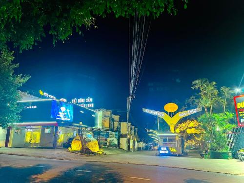 a city street at night with a gas station at D'Villa Hotel - Homestay in Kon Tum