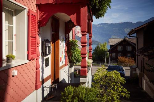 an entrance to a red building with an archway at Boutique-Hotel Schlüssel in Beckenried