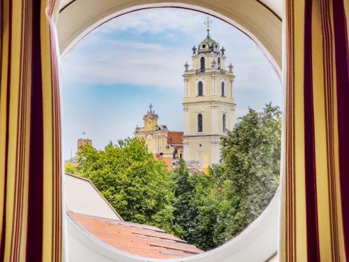 a view of a clock tower from a window at Relais & Ch&acirc;teaux Stikliai Hotel in Vilnius