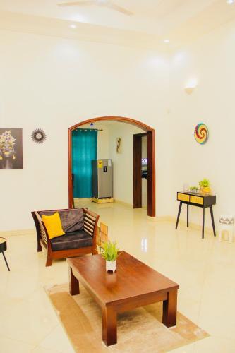 a living room with a couch and a coffee table at Lovely 4 Bedroom Solar Powered House with CCTV and Unlimited WiFi near Devtraco Court Community 25 Tema in Tema