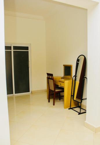 a room with a desk with a computer and a chair at Lovely 4 Bedroom Solar Powered House with CCTV and Unlimited WiFi near Devtraco Court Community 25 Tema in Tema