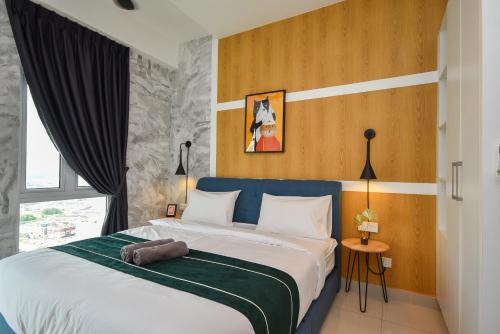 a bedroom with a large bed with a blue headboard at Twin Galaxy Suite by Nest Home in Johor Bahru