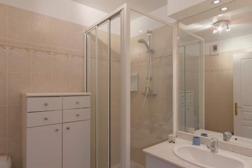 a bathroom with a shower and a sink at Beaudelaire Center Residence in Paris