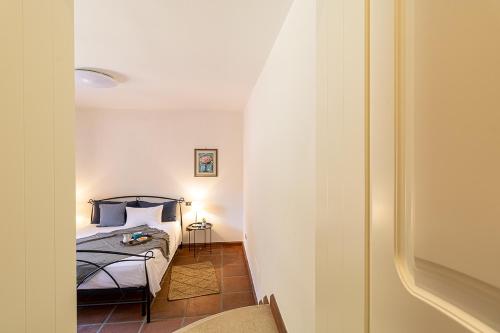 a bedroom with a bed with blue pillows at Villa Caterina in La Maddalena