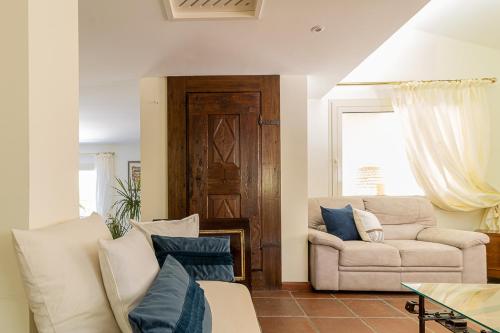 a living room with a couch and a chair at Villa Caterina in La Maddalena