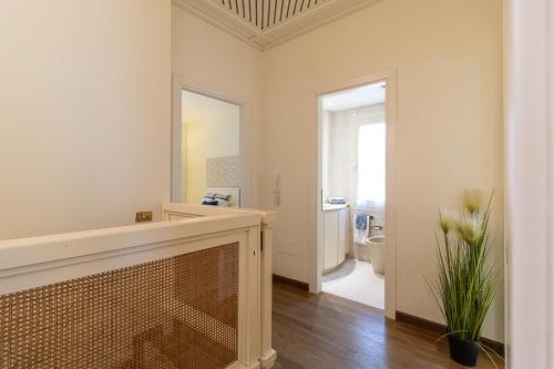 a white room with a fireplace and a bathroom at Villa Caterina in La Maddalena