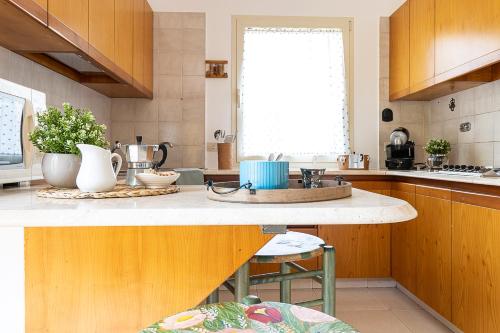 a kitchen with wooden cabinets and a counter top at Villa Caterina in La Maddalena