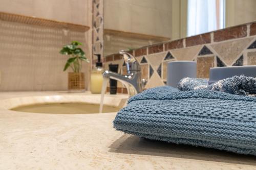 a bathroom with a sink and a towel on the floor at Villa Caterina in La Maddalena