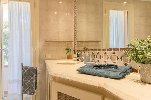 a bathroom with a sink and a mirror at Villa Caterina in La Maddalena