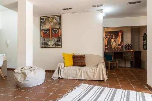 a living room with a couch and a painting on the wall at Villa Caterina in La Maddalena