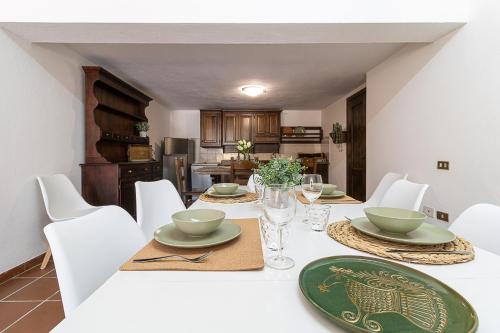a dining room with a table with white chairs at Villa Caterina in La Maddalena