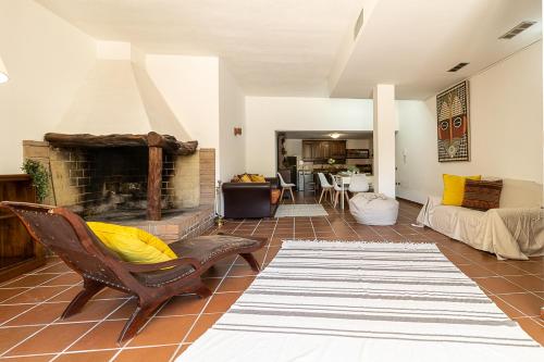 a living room with a fireplace and a couch at Villa Caterina in La Maddalena