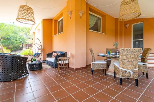 a patio with chairs and a table in a room at Villa Caterina in La Maddalena