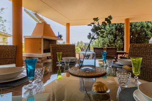 a dining table with glasses and plates on it at Villa Caterina in La Maddalena
