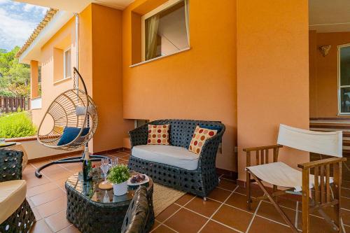 a patio with a chair and a table and chairs at Villa Caterina in La Maddalena