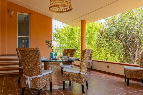 a patio with a table and chairs on a porch at Villa Caterina in La Maddalena