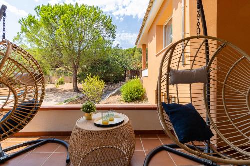 two chairs and a table on a balcony with a window at Villa Caterina in La Maddalena