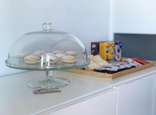 a glass plate with cupcakes on top of a counter at Terrazza sui Trabocchi in Marina San Vito