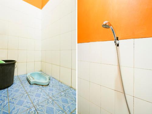 a bathroom with a shower and a blue floor at SPOT ON 91609 Pondok Mill's Syariah in Bandung