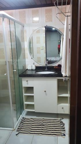 een badkamer met een wastafel en een spiegel bij Chalé em Barreirinhas 599,00 6 pessoas in Itaqui