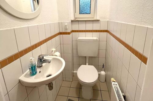 a small bathroom with a toilet and a sink at Apartment in Celle for Business Traveler in Celle
