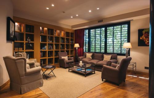 a living room filled with furniture and a large window at Hotel Mas La Boella in La Canonja