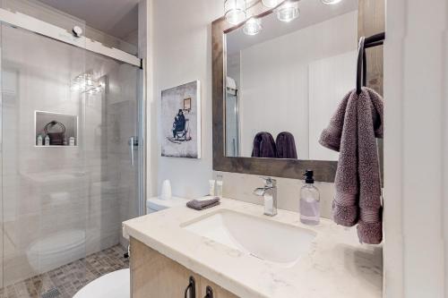 Un baño blanco con lavabo y ducha. en Golden Leaf Charmer, en Idyllwild