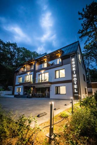 a large building with lights in front of it at 4 Évszak Erdeihotel**** - Mátrafüred in Mátrafüred