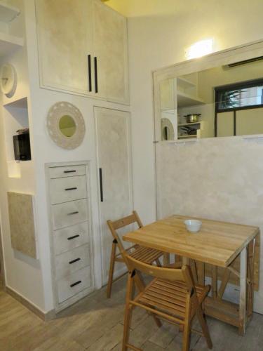 a dining room with a table and a kitchen at Terrace in Monti44a in Rome