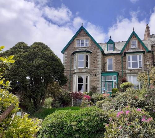 a large brick house with a green roof at Penrose Bed & Breakfast in Lostwithiel