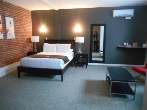 a hotel room with a bed and a mirror at Century Casino & Hotel Cripple Creek in Cripple Creek