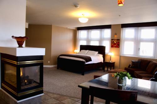 a living room with a bed and a fireplace at Century Casino & Hotel Cripple Creek in Cripple Creek