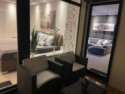 a bedroom with a bed and two chairs and a mirror at Live to Lion in Braunschweig