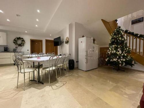 a kitchen with a christmas tree and a table and chairs at Casa Andreea in Vatra Dornei
