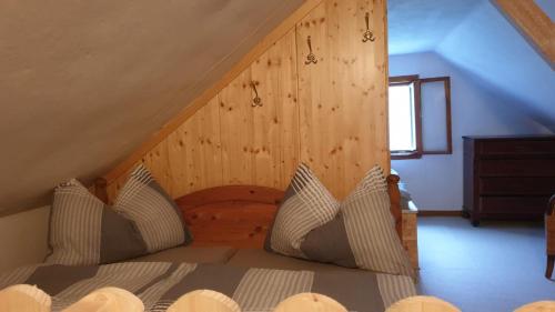 a bedroom with a bed with a wooden wall at Wiener Mühle in Malta