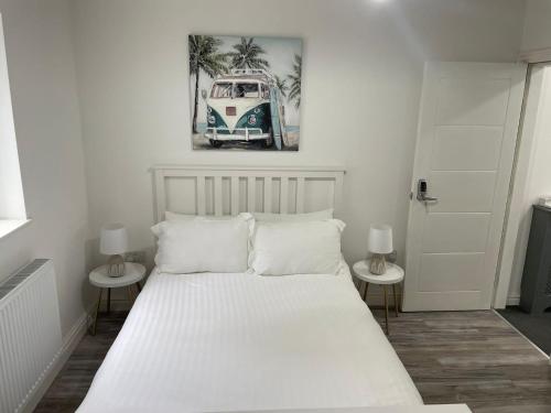 a bedroom with a white bed with two side tables at CityBreaks Rooms with Free Parking in Liverpool