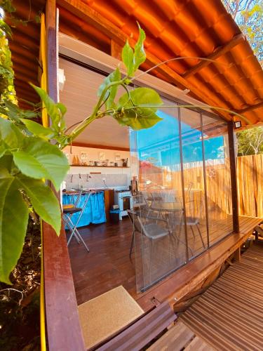 a screened in porch of a house with a table and chairs at Martinelli Residence in Fernando de Noronha